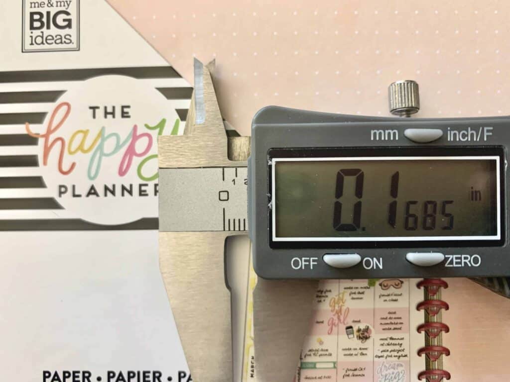 A photograph of The Happy Planner dot grid spacing measured with digital calipers in inches